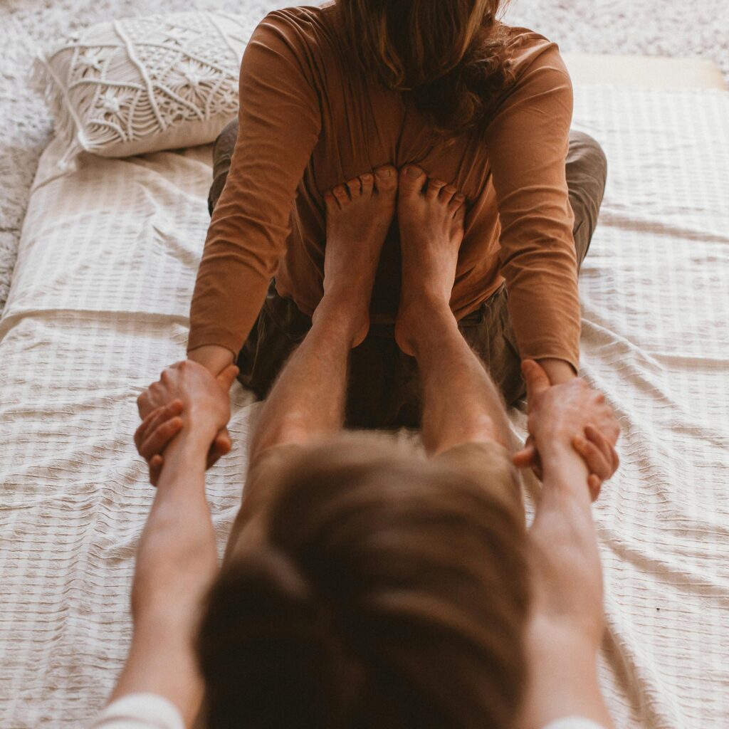 A couple engaged in a therapeutic massage session indoors, showcasing connection and relaxation.