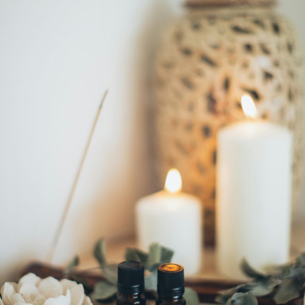 Tranquil scene featuring essential oils, candles, and eucalyptus for a relaxing atmosphere.