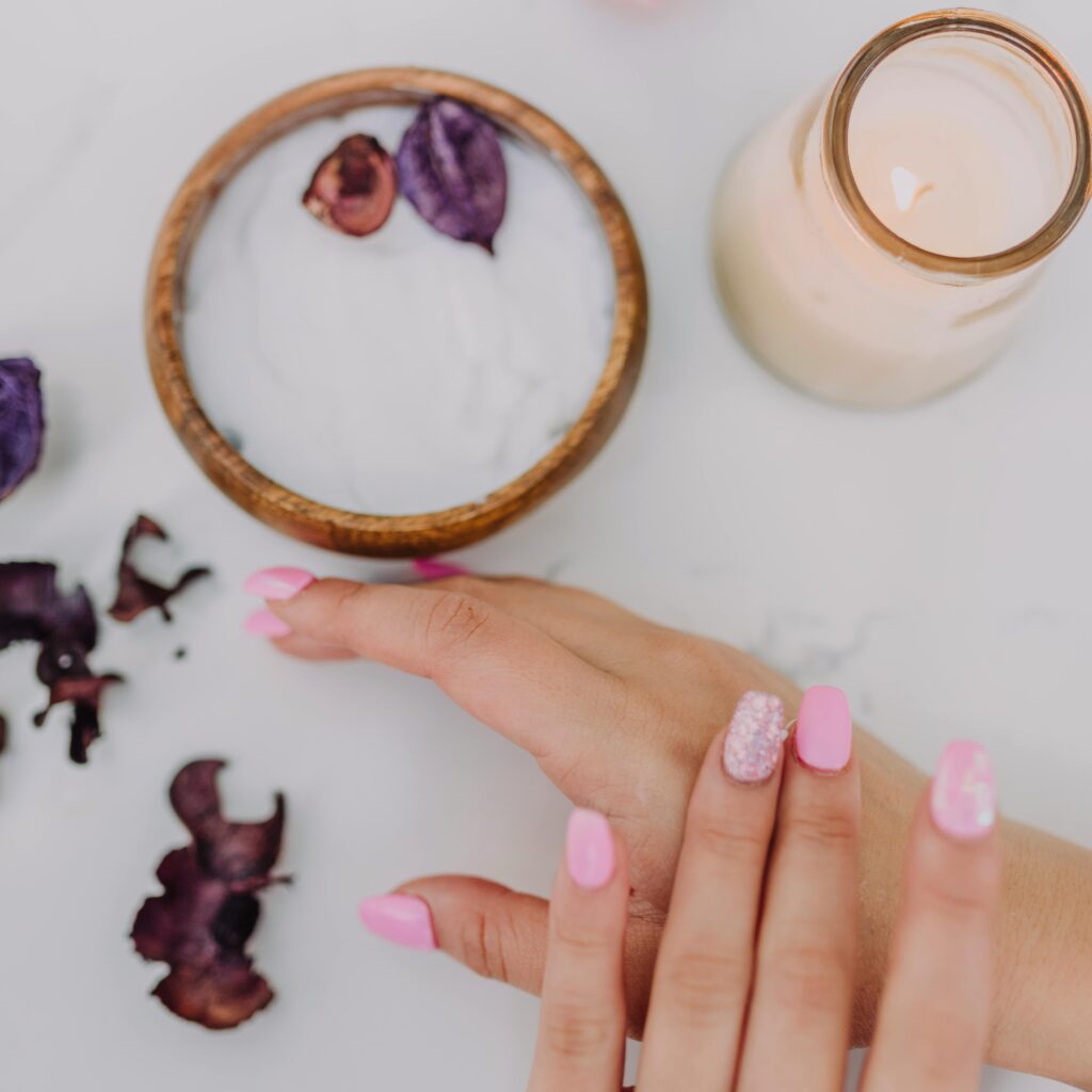 Beautiful pink manicure and spa products create a calming and luxurious experience.